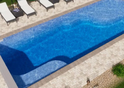 Rectangular inground fiberglass pool with sitting areas along the edges
