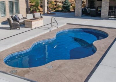 Smaller wavy edged inground pool with stairs and different depths