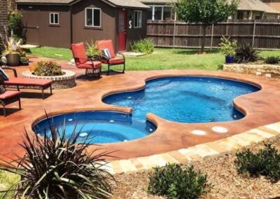Smaller wavy edged inground pool with stairs and different depths with attached spa