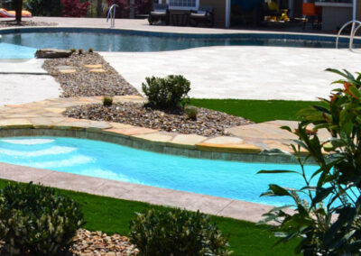 2 inground pools with curved edges one is smaller