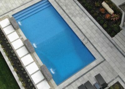 Simple rectangular pool with steps that go across full width