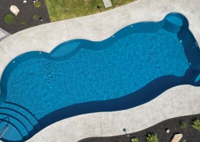 Aerial view of inground fiberglass pool with concrete suround