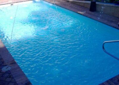 Simple rectangular fiberglass pool with hand rail