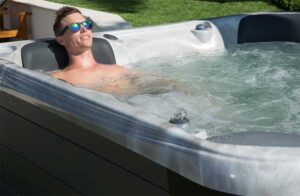 Man with sunglasses relaxing in a Sunrise Series S hot tub