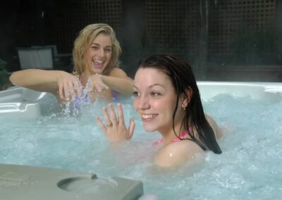 2 Girls splashing in a Sunrise Hot Tub having fun